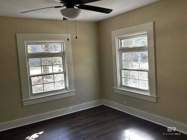 empty room featuring dark hardwood / wood-style floors and ceiling fan