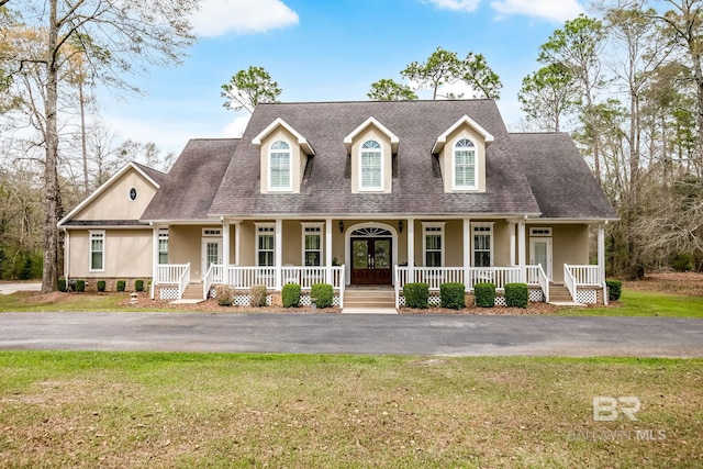 new england style home with a front lawn and covered porch