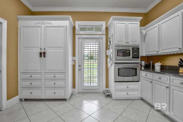 kitchen with white cabinetry, appliances with stainless steel finishes, light tile floors, and crown molding