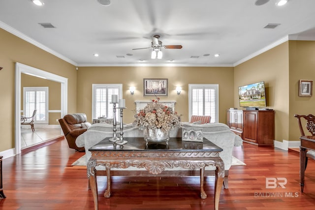 dining area with ceiling fan, ornamental molding, plenty of natural light, and hardwood / wood-style flooring