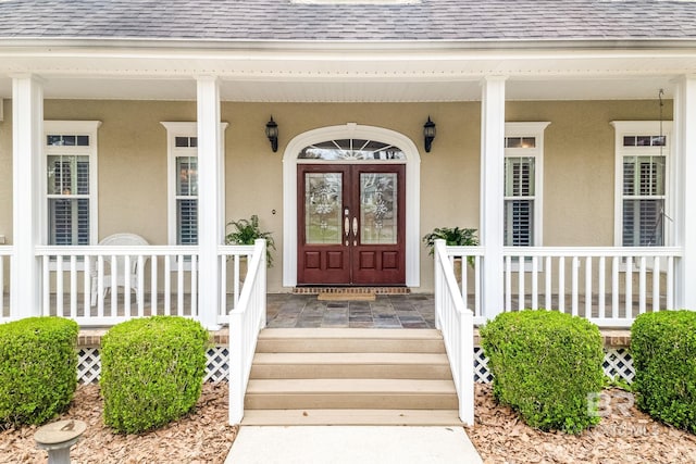 entrance to property featuring covered porch and french doors