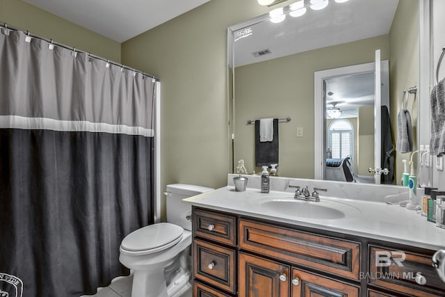 bathroom with large vanity, ceiling fan, and toilet