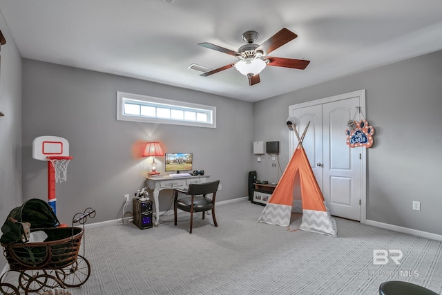 playroom with ceiling fan and light colored carpet