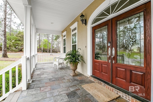 doorway to property featuring covered porch