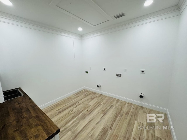 laundry room with visible vents, attic access, hookup for a washing machine, light wood-type flooring, and electric dryer hookup