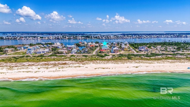 birds eye view of property with a beach view and a water view