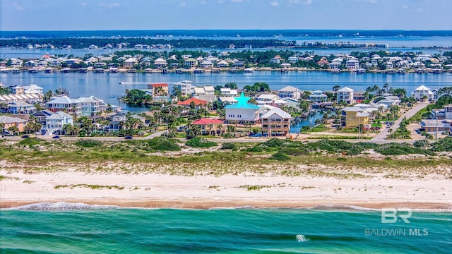 aerial view with a view of the beach, a residential view, and a water view