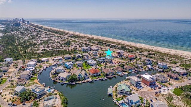 bird's eye view featuring a water view and a beach view