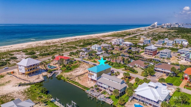 drone / aerial view featuring a water view and a view of the beach