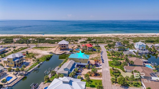 drone / aerial view with a beach view and a water view