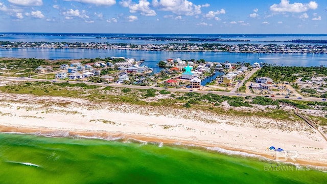 bird's eye view featuring a water view and a beach view