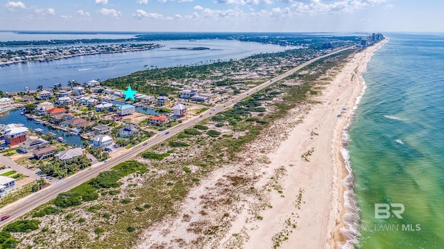 drone / aerial view featuring a water view and a view of the beach