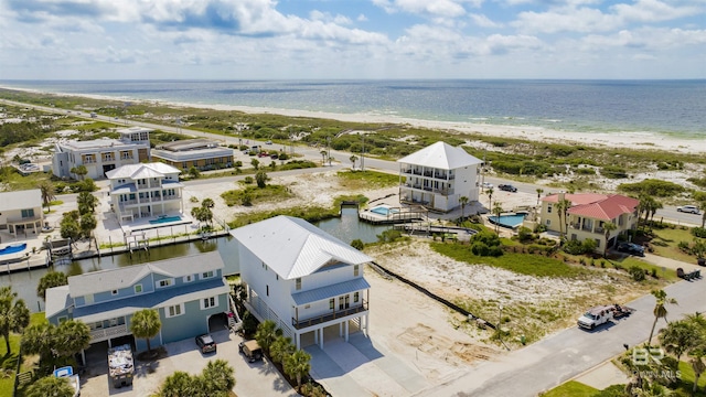 drone / aerial view with a water view and a view of the beach