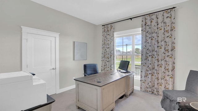 office with light carpet and baseboards