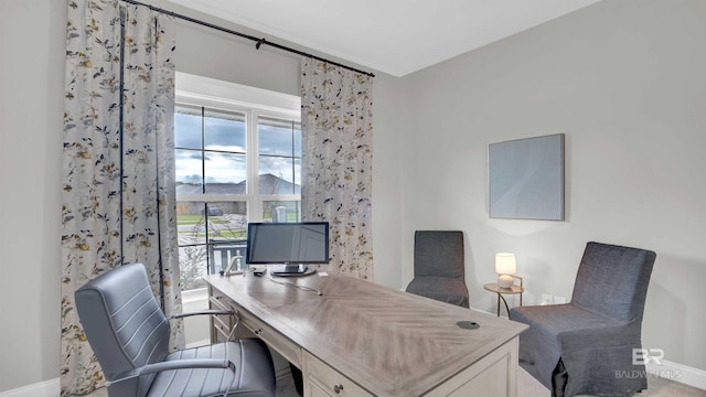 home office with baseboards and a healthy amount of sunlight