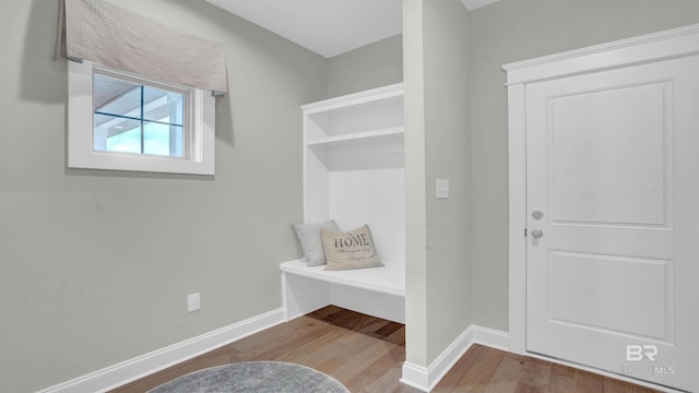 mudroom featuring wood finished floors and baseboards