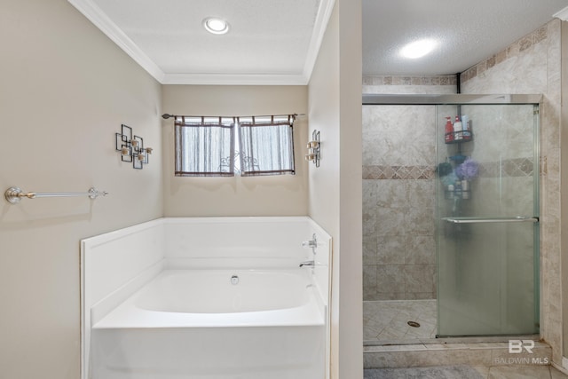 bathroom with ornamental molding, separate shower and tub, and a textured ceiling