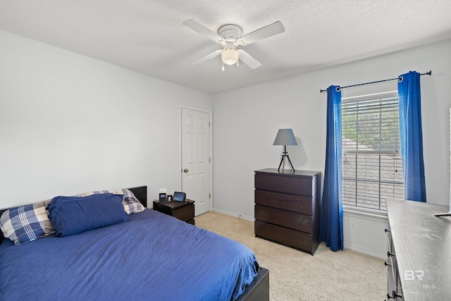 carpeted bedroom with a textured ceiling and ceiling fan