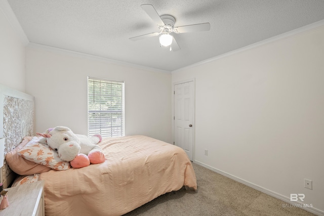 carpeted bedroom featuring a textured ceiling, ceiling fan, and ornamental molding