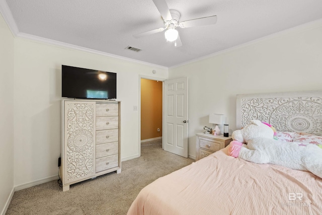 carpeted bedroom with ceiling fan and crown molding