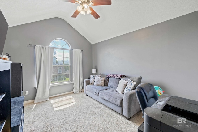 carpeted living room with ceiling fan and vaulted ceiling