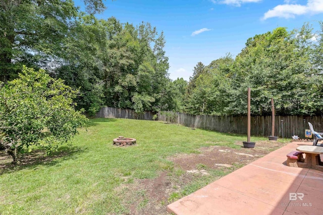 view of yard with a fire pit and a patio area