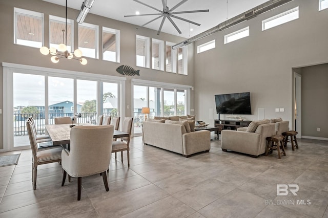 living room with a towering ceiling and a notable chandelier