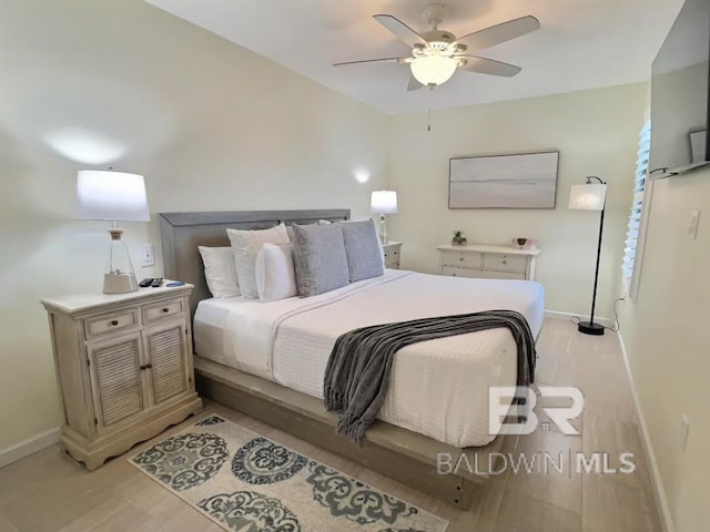 bedroom with ceiling fan and light hardwood / wood-style flooring