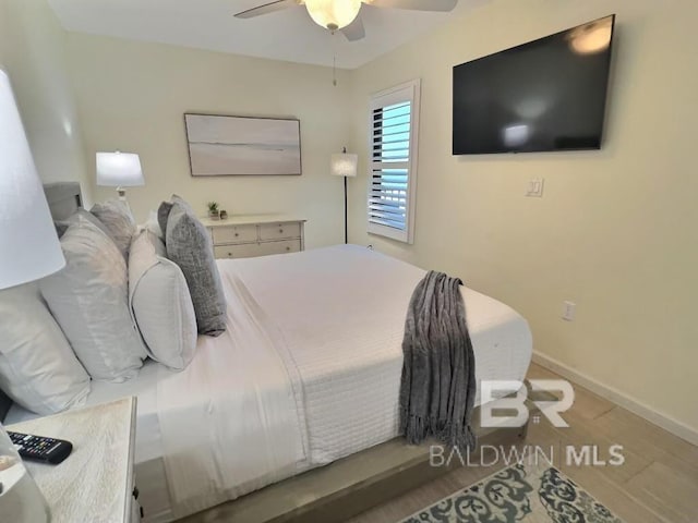 bedroom with wood-type flooring and ceiling fan