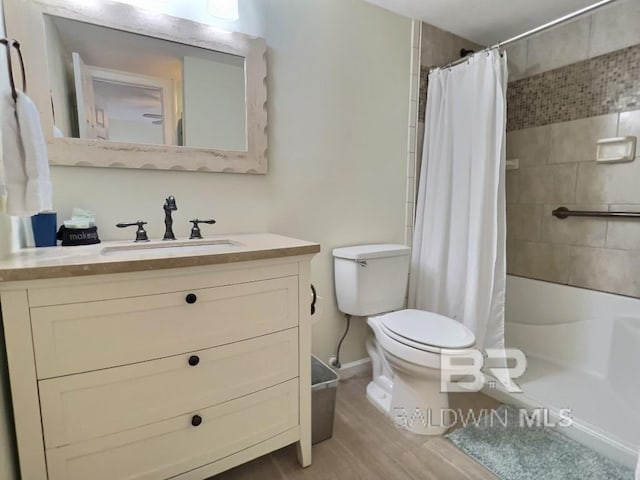 bathroom with vanity, toilet, and hardwood / wood-style flooring