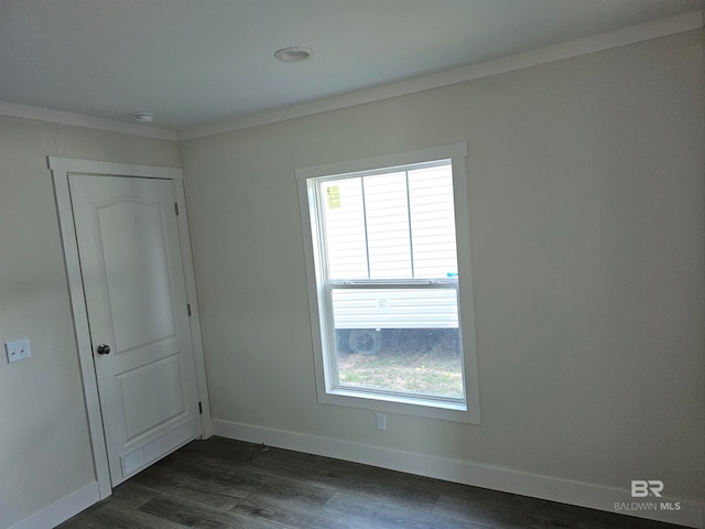 unfurnished room featuring plenty of natural light and dark hardwood / wood-style floors