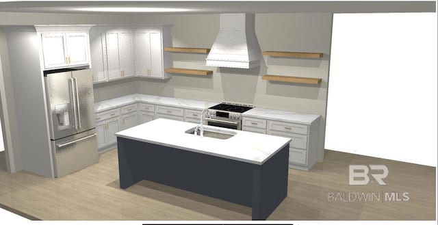 kitchen with sink, stainless steel appliances, range hood, an island with sink, and light wood-type flooring