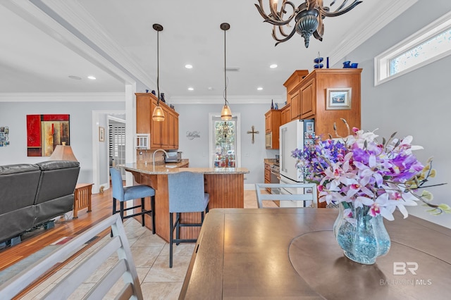 dining space featuring crown molding, recessed lighting, baseboards, and a chandelier