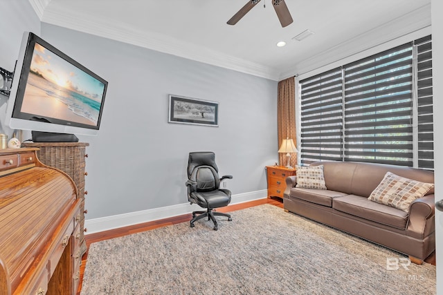 home office featuring crown molding, baseboards, a ceiling fan, and wood finished floors