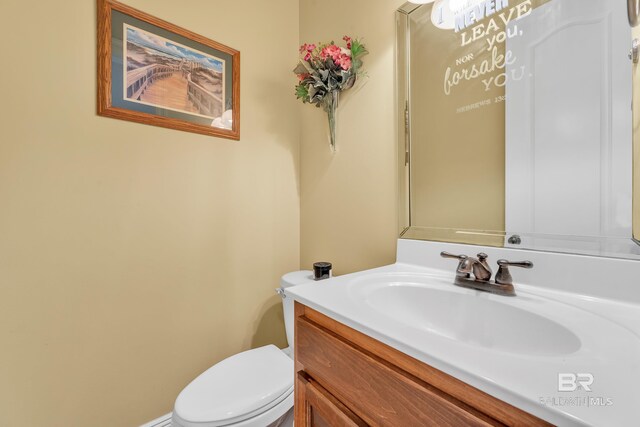 half bath featuring toilet and vanity