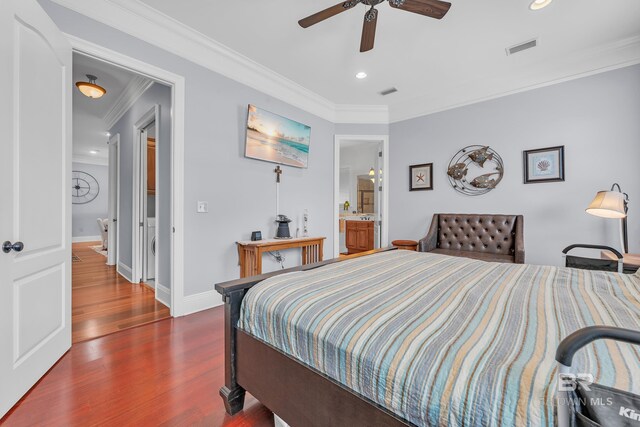 bedroom with visible vents, ornamental molding, wood finished floors, baseboards, and recessed lighting