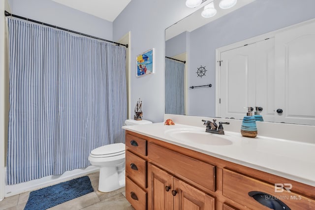 bathroom with toilet, tile patterned floors, and vanity