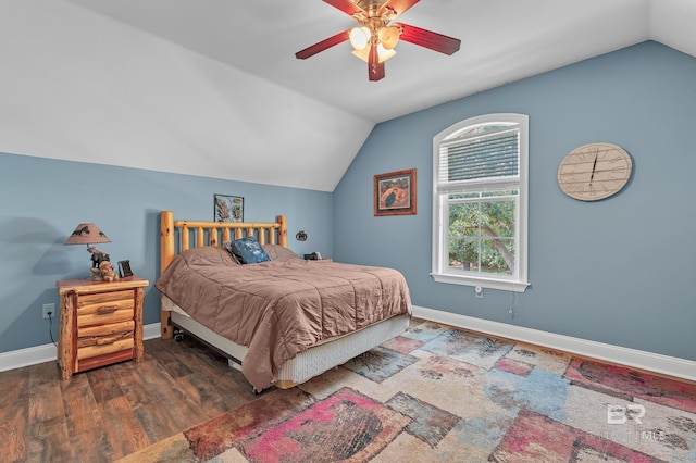 bedroom with a ceiling fan, baseboards, vaulted ceiling, and wood finished floors