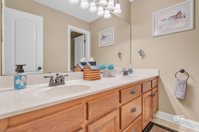 full bathroom with double vanity, a sink, and tile patterned flooring