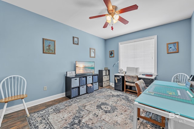office space with a ceiling fan, baseboards, and wood finished floors
