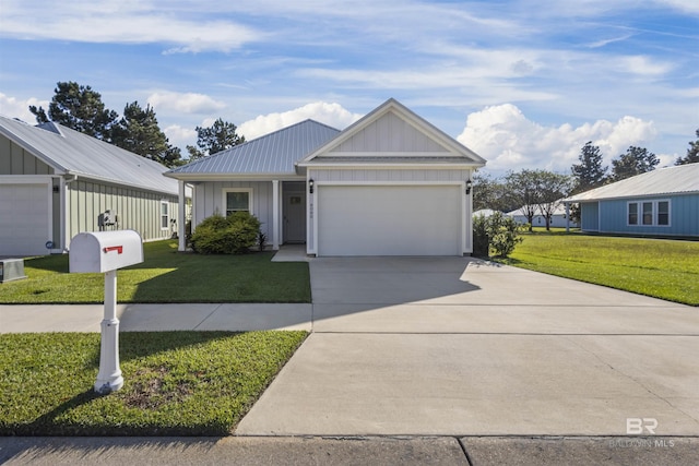 view of front of property featuring an attached garage, driveway, board and batten siding, and a front yard