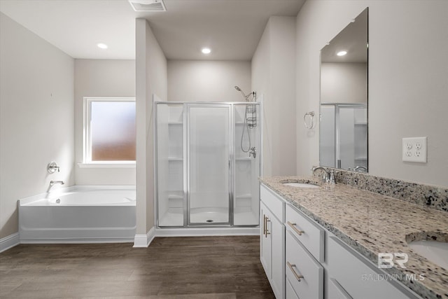 bathroom with independent shower and bath, vanity, and hardwood / wood-style flooring