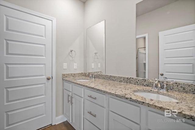 bathroom with vanity and hardwood / wood-style floors