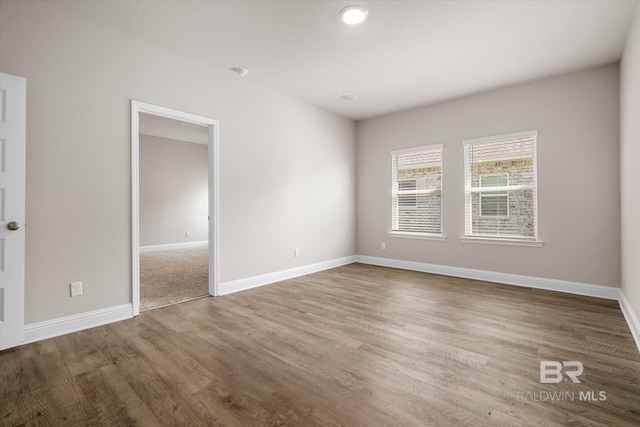 spare room featuring wood-type flooring