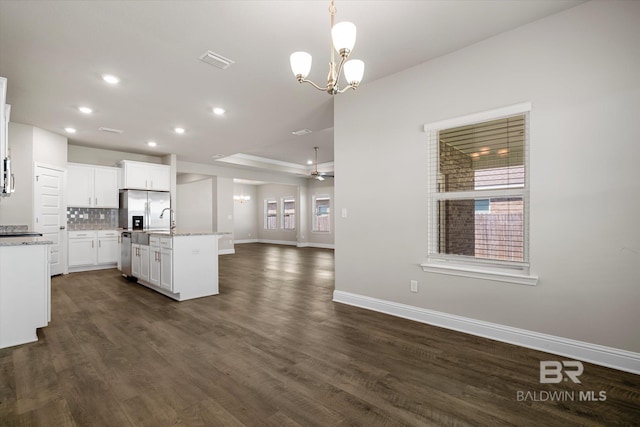 kitchen featuring a kitchen island with sink, dark wood-type flooring, pendant lighting, and white cabinetry