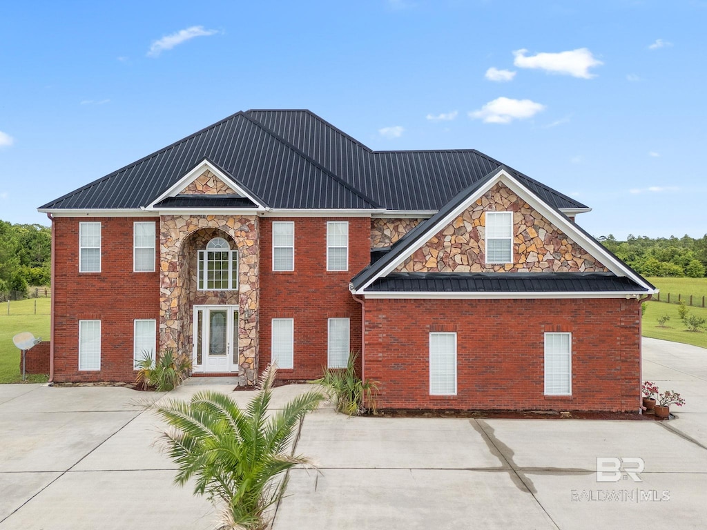 9790 Stucki Rd, Elberta, AL 36530 - view of front of home featuring driveway, brick siding, metal roof, and stone siding