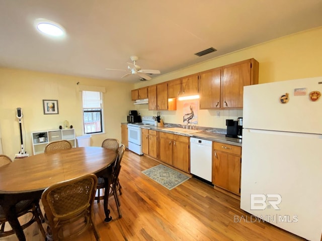 106 Ryan Ct, Dauphin Island, AL 36528 - kitchen featuring white appliances, a sink, light wood-style floors, a ceiling fan, and under cabinet range hood