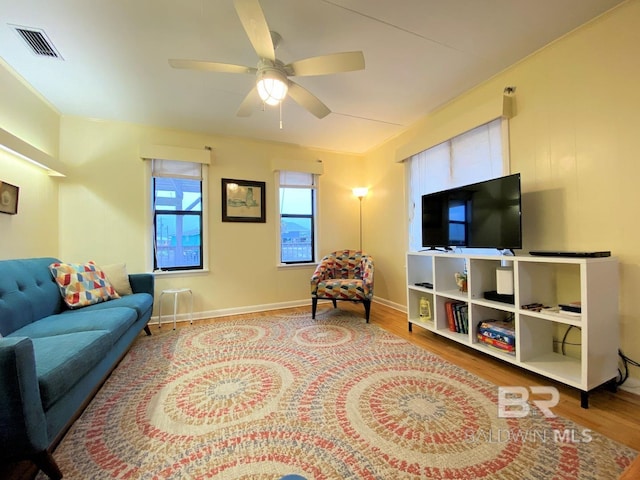 106 Ryan Ct, Dauphin Island, AL 36528 - living room with wood finished floors, ceiling fan, and baseboards