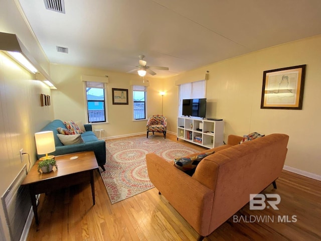 106 Ryan Ct, Dauphin Island, AL 36528 - living room featuring light wood-type flooring, ceiling fan, and baseboards