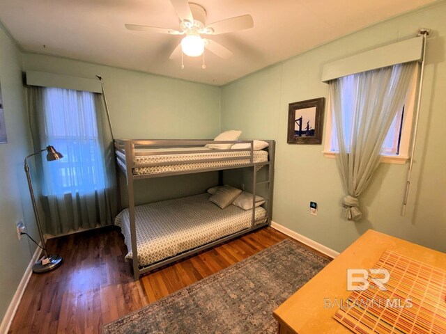 106 Ryan Ct, Dauphin Island, AL 36528 - bedroom with wood finished floors, baseboards, and a ceiling fan